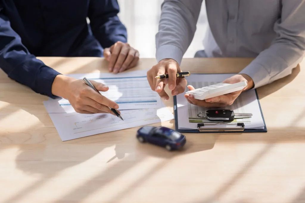 Insurance agent reviewing an auto policy with clients